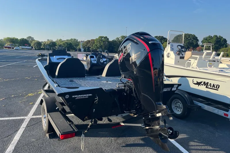 Slide: The Image of 2026 Tracker Pro Team 190 boat with powerful outboard motor in parking lot. - 3