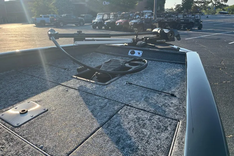 Slide: The Image of 2026 Tracker Pro Team 190 boat deck with trolling motor in parking lot. - 8