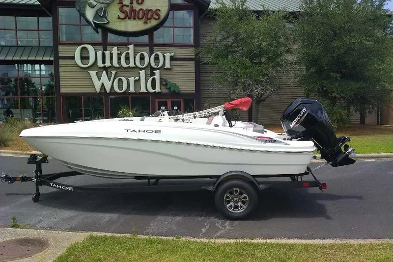 Slide: The Image of 2026 Tahoe T18 boat on trailer outside Outdoor World store. - 75