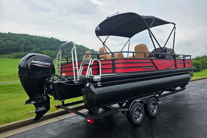 Slide: The Image of 2026 Ranger 220F pontoon boat with Mercury engine on a trailer, parked outdoors. - 3