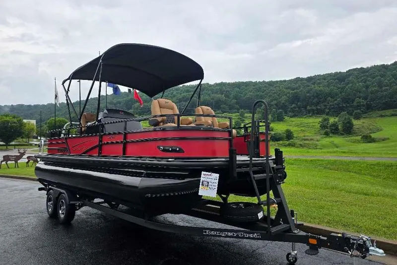 The Image of 2026 Ranger 220F pontoon boat with canopy on trailer, set against a scenic landscape. - 0