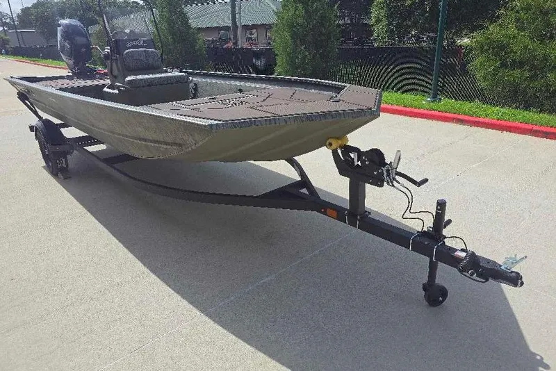 Slide: The Image of 2026 Tracker Grizzly 1860 CC boat on trailer, parked outdoors. - 2