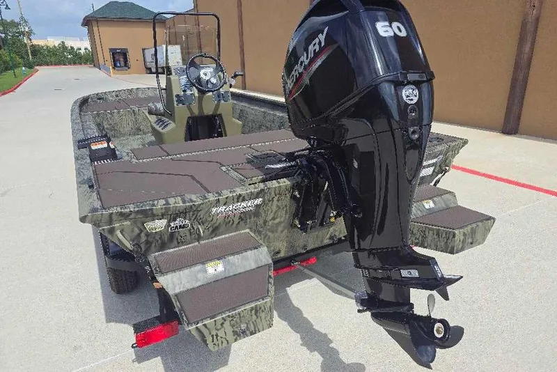 Slide: The Image of 2026 Tracker Grizzly 1860 CC boat with Mercury 60 outboard motor, parked outdoors. - 4