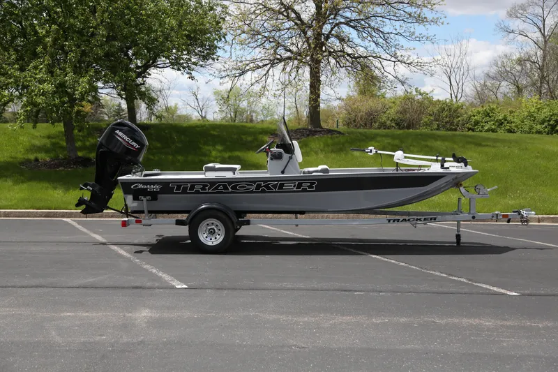 The Image of 2026 Tracker Bass Tracker Classic CC boat on trailer in parking lot. - 0