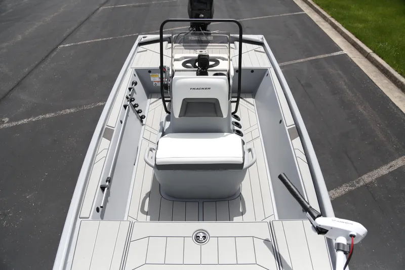 Slide: The Image of 2026 Tracker Bass Tracker Classic CC boat interior with steering console and seating. - 3