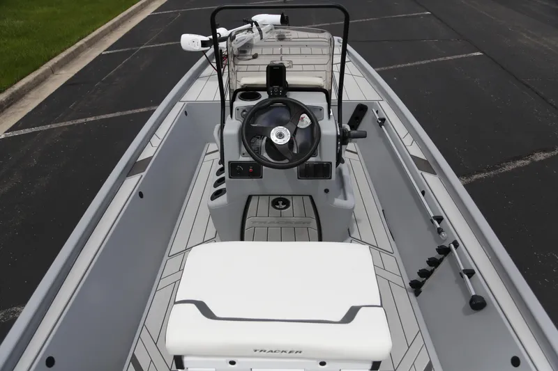 Slide: The Image of 2026 Tracker Bass Tracker Classic CC boat interior with steering console and seating. - 4