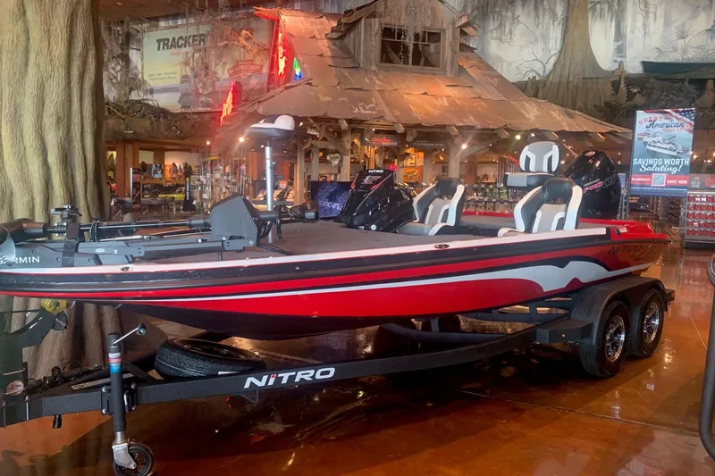 The Image of 2026 Nitro Z19 XL Pro boat displayed indoors, featuring sleek red design and modern seating. - 0