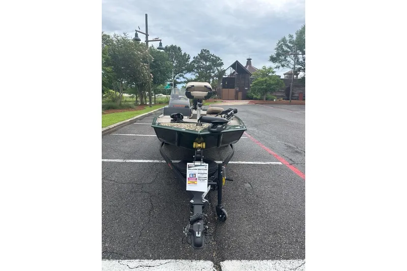 Slide: The Image of 2026 Tracker Bass Tracker Classic Limited boat parked in a lot, front view. - 3