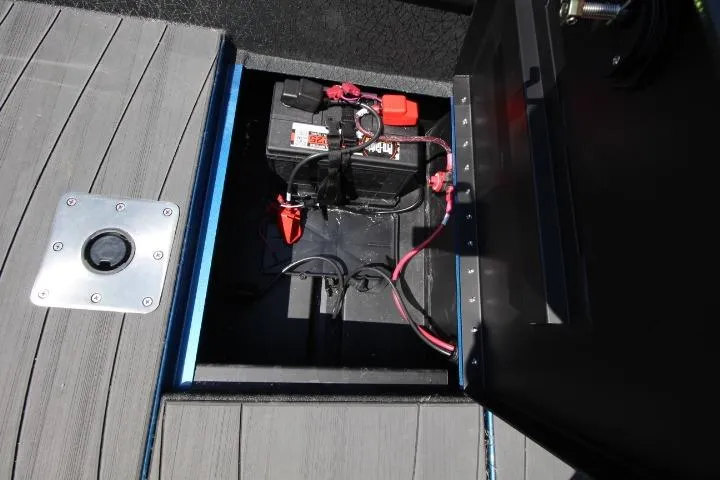 Slide: The Image of Battery compartment of 2026 Vexus ADX 190 boat, showcasing wiring and secure storage. - 16