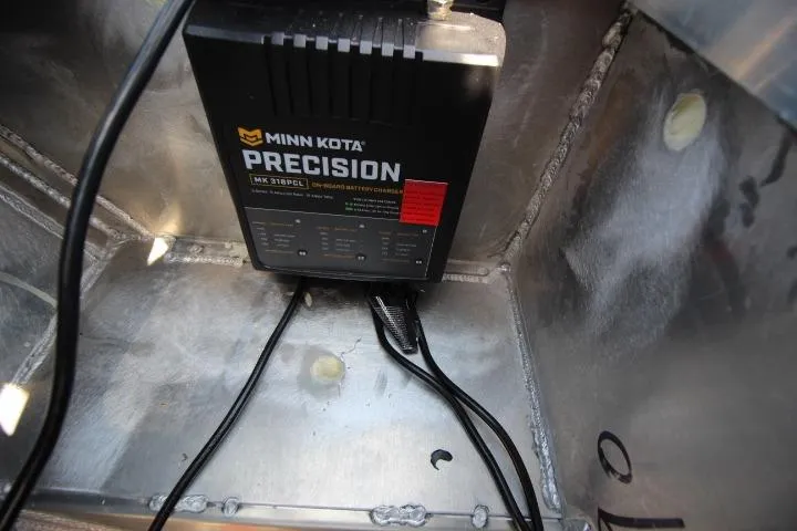 Slide: The Image of Minn Kota Precision charger installed in 2026 Vexus ADX 190 boat compartment. - 9
