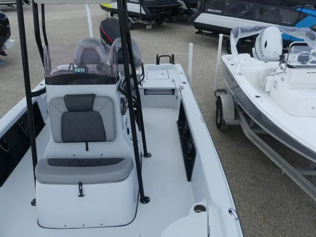 Slide: The Image of 2021 Blue Wave 2300 Pure Bay boat, interior view, gray seats, parked outdoors. - 15