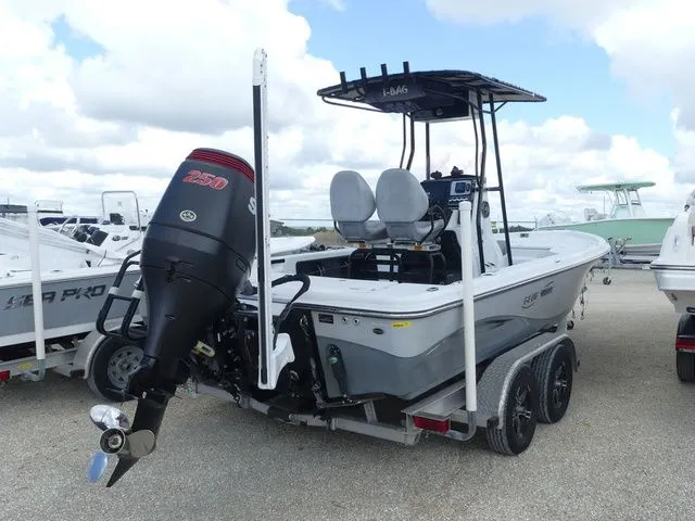 Slide: The Image of 2021 Blue Wave 2300 Pure Bay boat on trailer, outboard motor. - 4