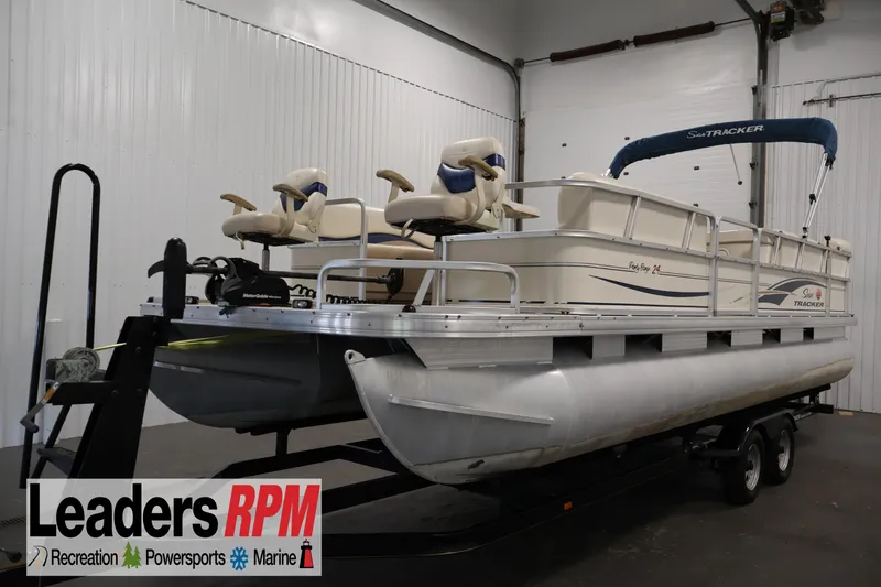 The Image of 2008 Sun Tracker Party Barge 24 DLX pontoon boat on trailer in indoor storage. - 0