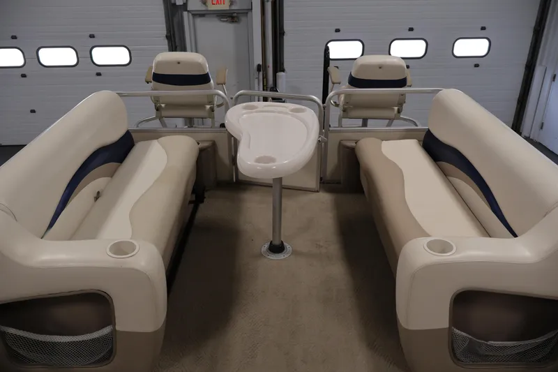 Slide: The Image of 2008 Sun Tracker Party Barge 24 DLX interior with beige seating and table. - 14