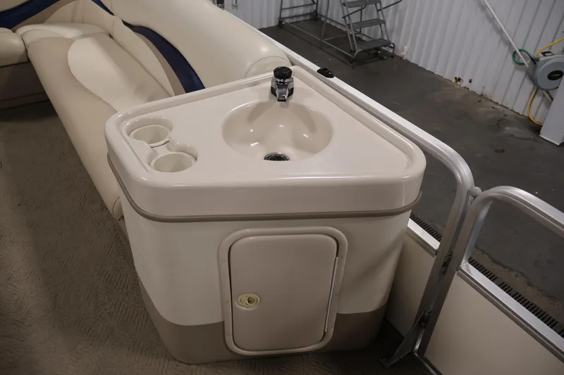 Slide: The Image of 2008 Sun Tracker Party Barge 24 DLX interior with sink and cup holders. - 16
