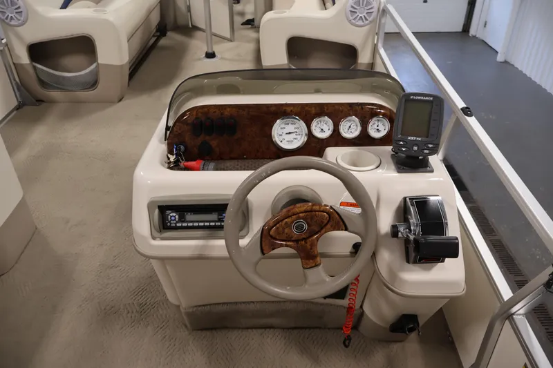 Slide: The Image of 2008 Sun Tracker Party Barge 24 DLX dashboard with steering wheel and navigation instruments. - 23