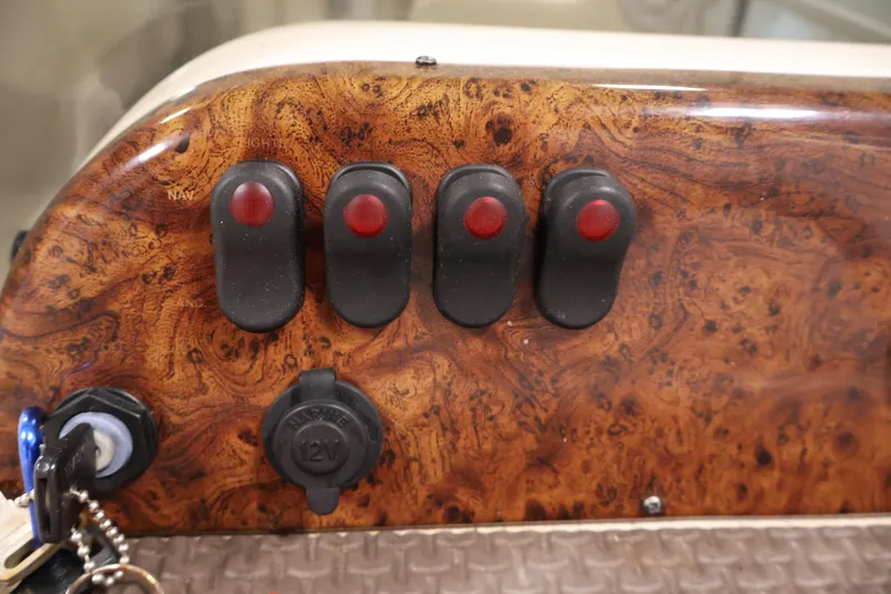 Slide: The Image of Control panel of a 2008 Sun Tracker Party Barge 24 DLX with switches and key ignition. - 27