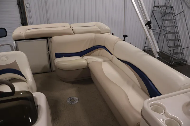 Slide: The Image of 2008 Sun Tracker Party Barge 24 DLX interior with beige and blue seating. - 32