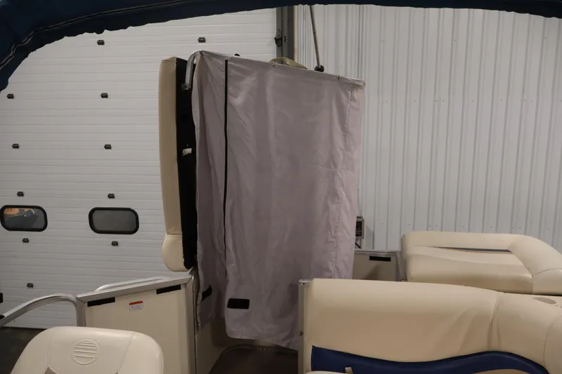 Slide: The Image of 2008 Sun Tracker Party Barge 24 DLX interior with privacy curtain in storage facility. - 36