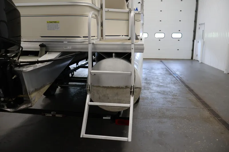 Slide: The Image of 2008 Sun Tracker Party Barge 24 DLX with ladder in indoor storage. - 37