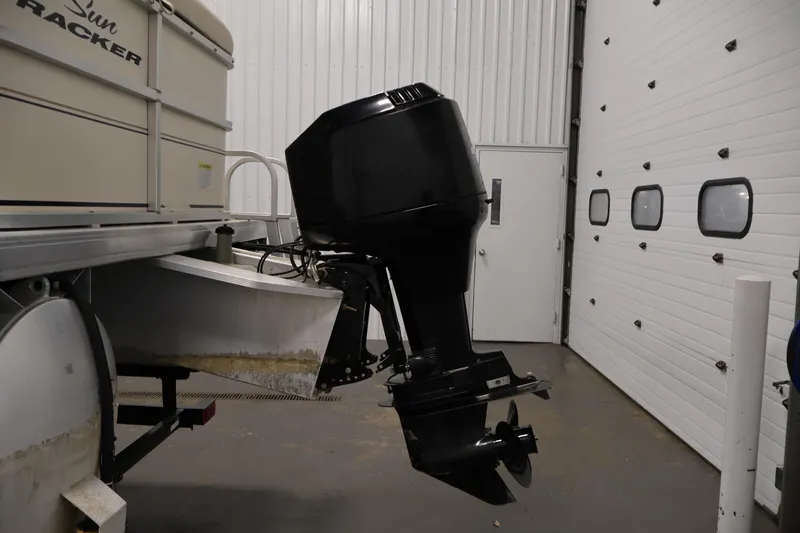 Slide: The Image of 2008 Sun Tracker Party Barge 24 DLX with outboard motor in a garage. - 39