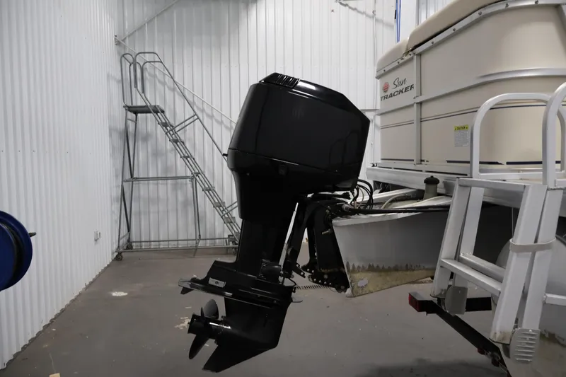 Slide: The Image of 2008 Sun Tracker Party Barge 24 DLX with outboard motor in storage facility. - 40