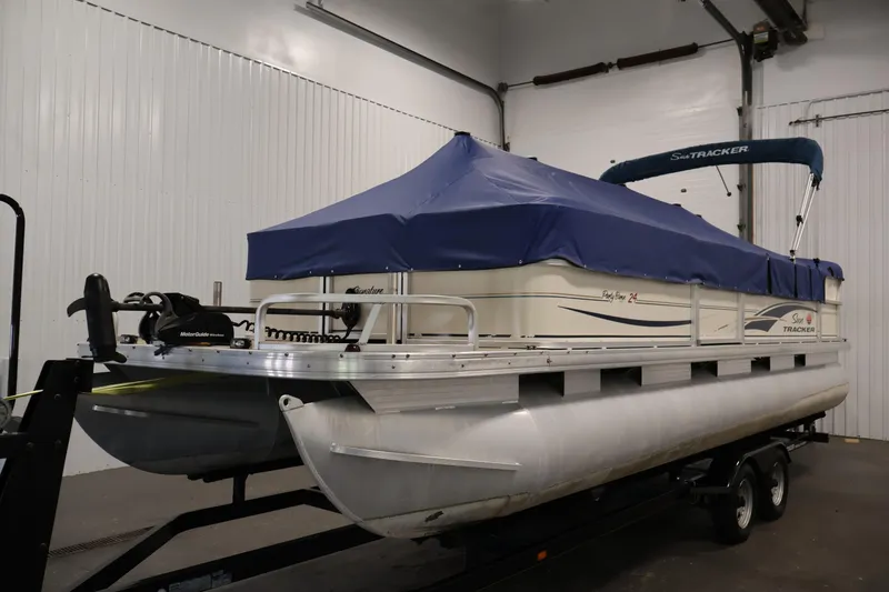 Slide: The Image of 2008 Sun Tracker Party Barge 24 DLX pontoon boat with blue cover in indoor storage. - 46