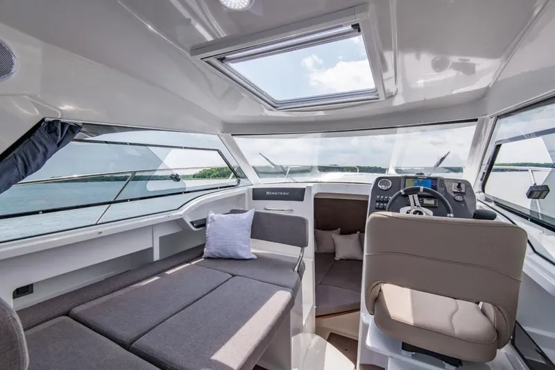 Slide: The Image of Interior of 2024 Beneteau Antares 8 boat with modern seating and panoramic windows. - 10