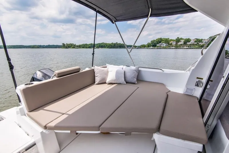 Slide: The Image of 2024 Beneteau Antares 8 boat with spacious deck seating and scenic water view. - 18