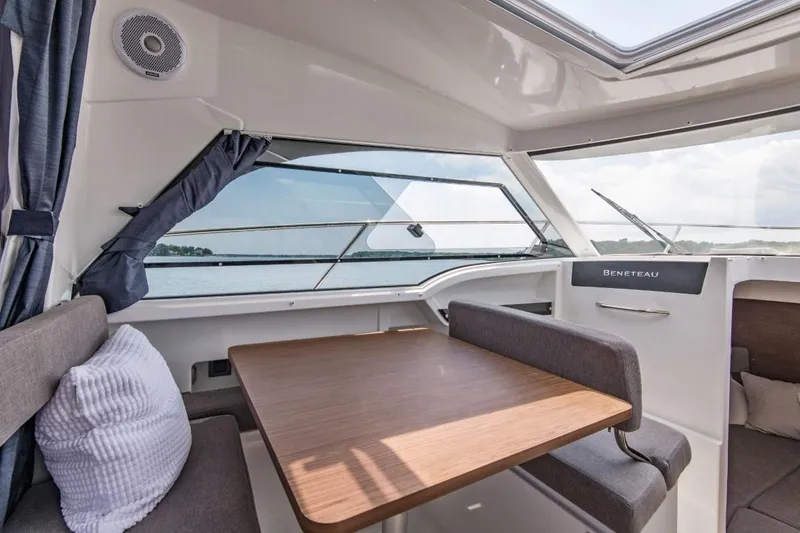 Slide: The Image of Interior of 2024 Beneteau Antares 8 with dining table and sea view. - 12