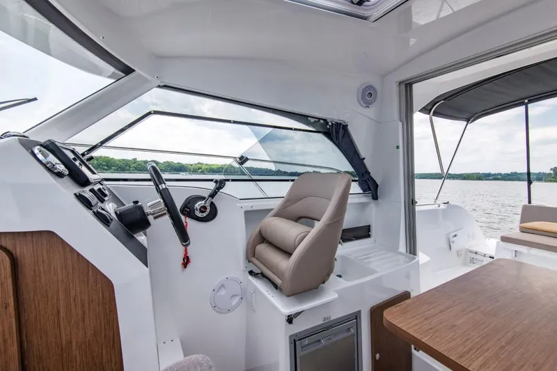 Slide: The Image of Interior of 2024 Beneteau Antares 8 boat with helm station and seating. - 6