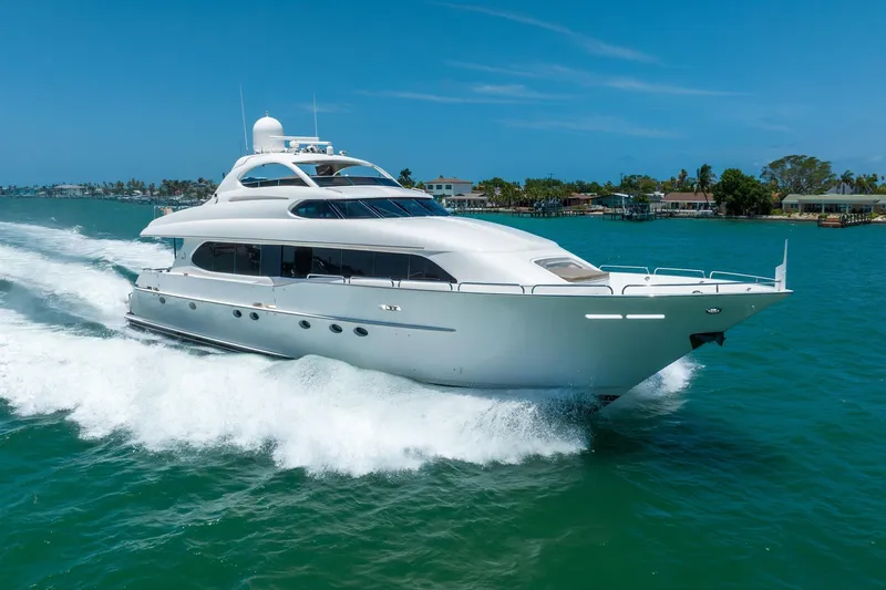 Slide: The Image of Luxurious 2001 Lazzara 94 yacht cruising on clear blue waters under a sunny sky. - 0