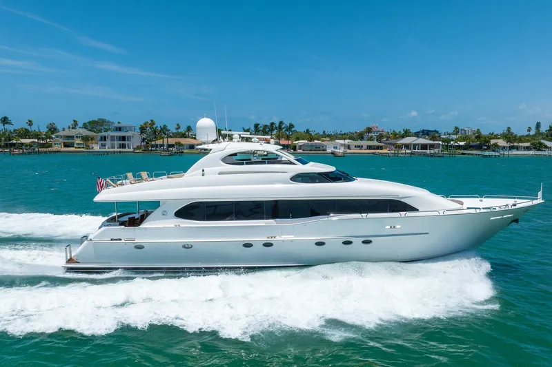 Slide: The Image of Luxurious 2001 Lazzara 94 yacht cruising on turquoise waters under a clear blue sky. - 1