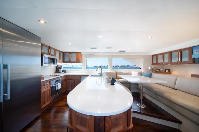 Slide: The Image of Luxurious kitchen and dining area on a 2001 Lazzara 94 yacht, featuring modern appliances and elegant design. - 15
