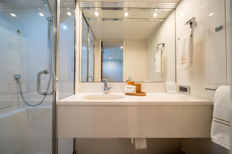 Slide: The Image of Luxurious bathroom in a 2001 Lazzara 94 yacht, featuring modern fixtures and elegant design. - 27
