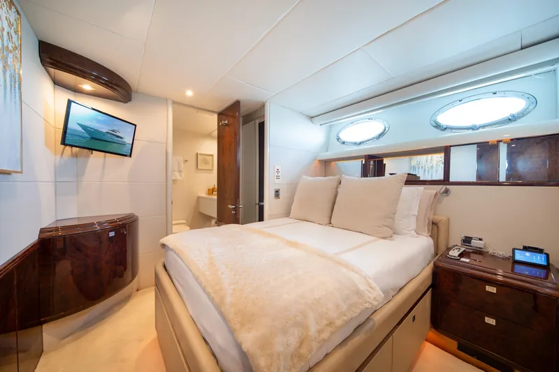 Slide: The Image of Luxurious bedroom interior of 2001 Lazzara 94 yacht with elegant furnishings and porthole windows. - 28