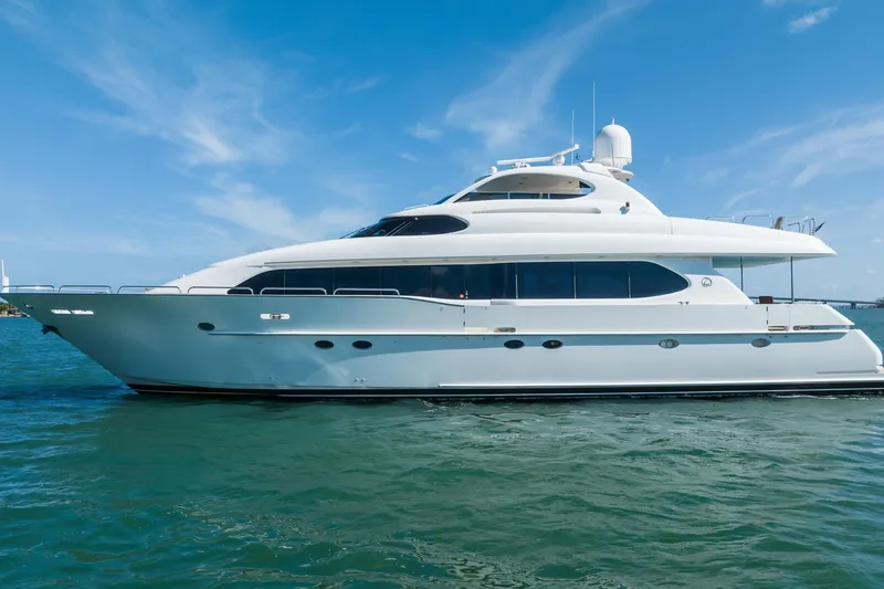 Slide: The Image of Luxury 2001 Lazzara 94 yacht cruising on clear blue waters under a sunny sky. - 3