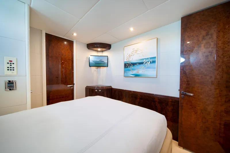 Slide: The Image of Luxurious bedroom interior on a 2001 Lazzara 94 yacht, featuring elegant wood finishes. - 31