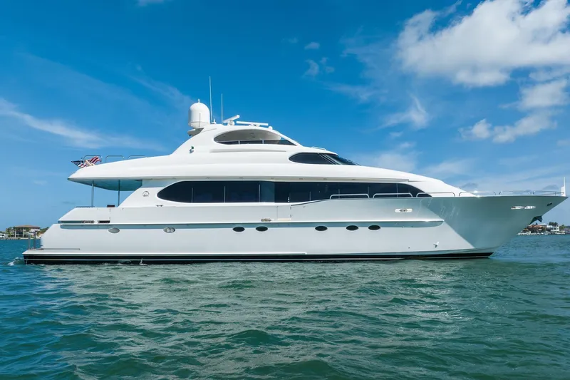 Slide: The Image of Luxury 2001 Lazzara 94 yacht cruising on clear blue waters under a sunny sky. - 4