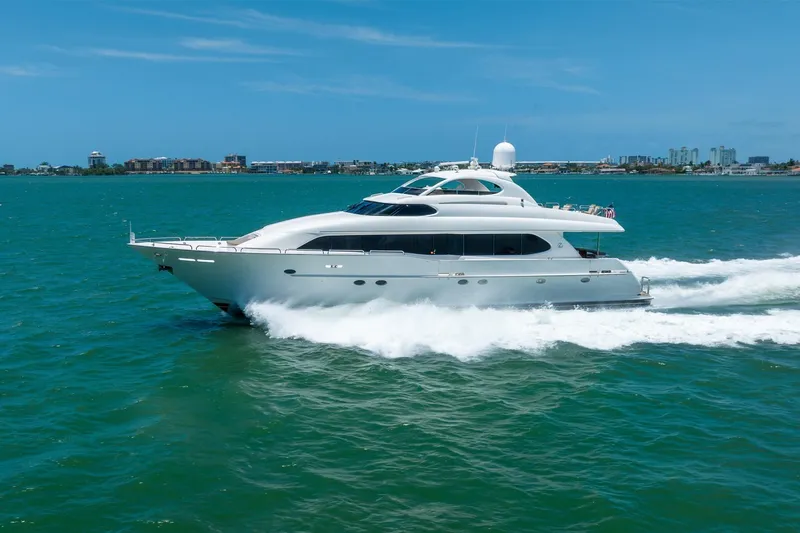 Slide: The Image of Luxury 2001 Lazzara 94 yacht cruising on open water under clear blue skies. - 5