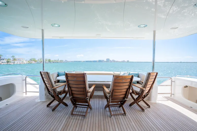 Slide: The Image of Luxury yacht deck with wooden chairs overlooking serene ocean view, Lazzara 94, 2001 model. - 7
