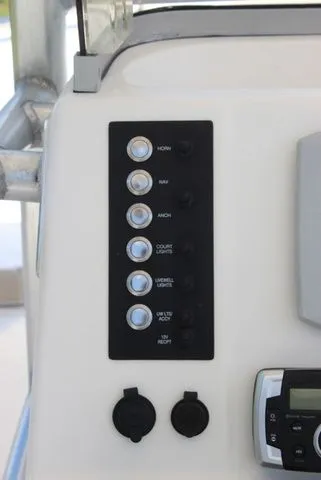 Slide: The Image of Control panel of a 2019 Robalo R222 boat with switches and controls. - 15