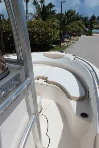 Slide: The Image of 2019 Robalo R222 boat with seating area and palm trees in background. - 22
