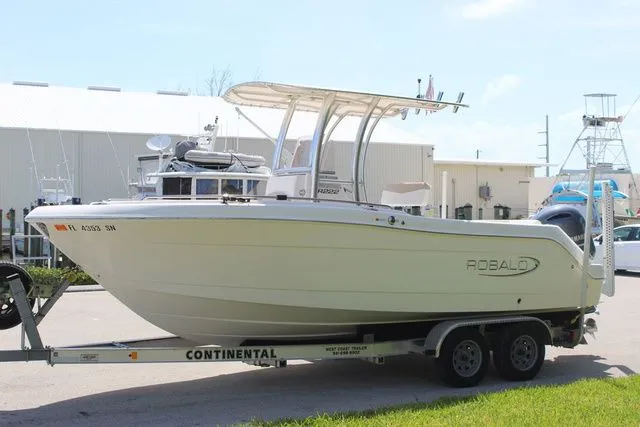 Slide: The Image of 2019 Robalo R222 boat on trailer in front of building. - 4