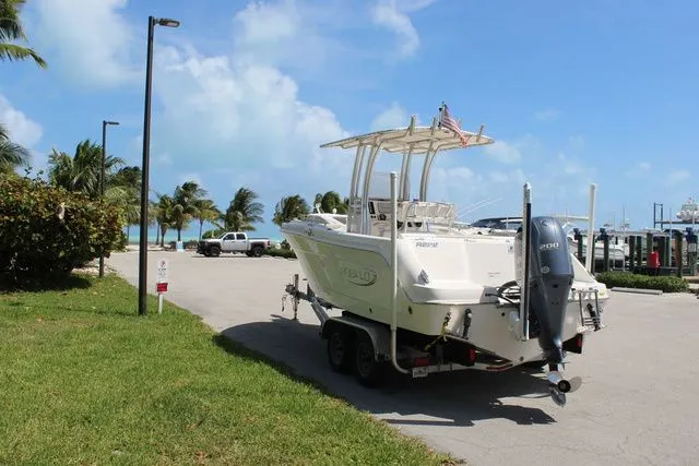 Slide: The Image of 2019 Robalo R222 boat on trailer near beach. - 9