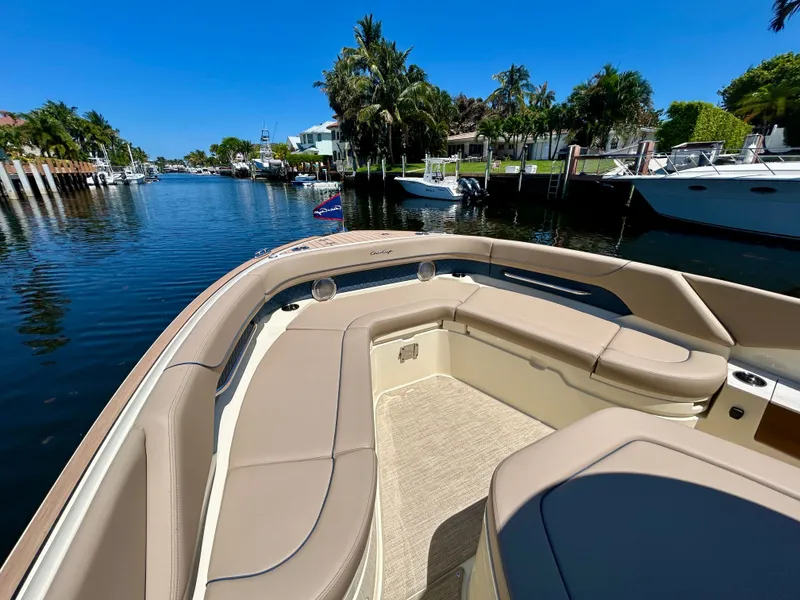 Slide: The Image of Chris-Craft Catalina 28, 2026, on calm water with palm trees in the background. - 6