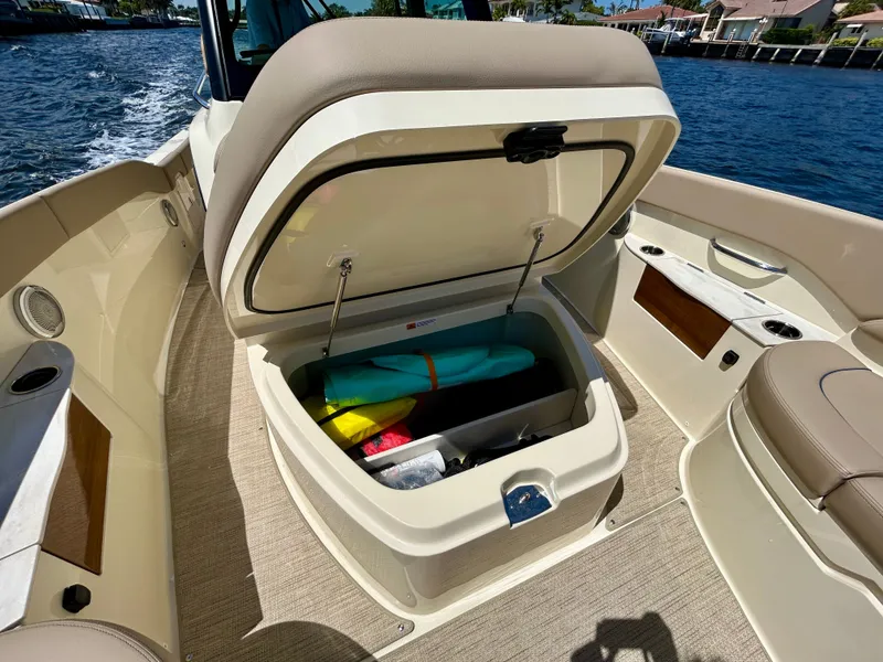 Slide: The Image of Chris-Craft Catalina 28, 2026, with open storage compartment by the water. - 8