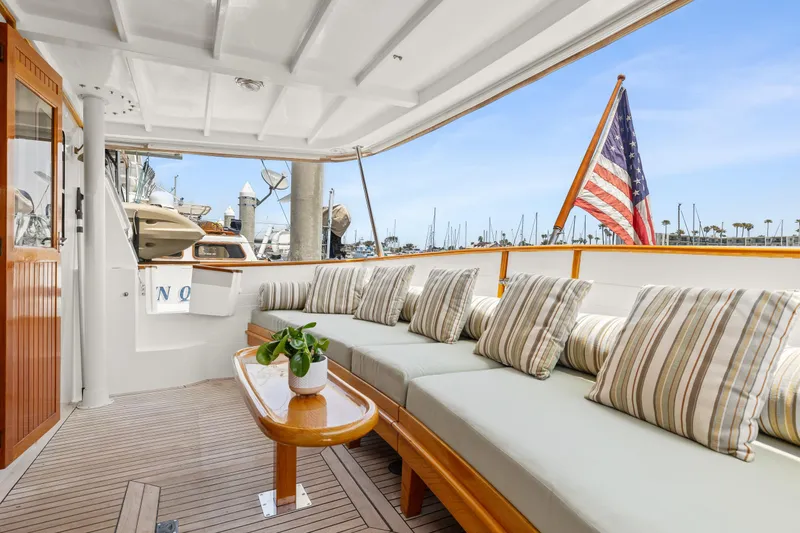 Slide: The Image of Kadey-Krogen 48 Whaleback 1996 yacht with cozy deck and American flag. - 9