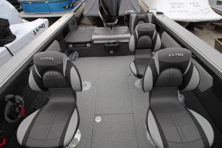 Slide: The Image of 2026 Lund 2075 Tyee boat interior with four cushioned seats and spacious deck layout. - 10