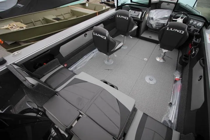 Slide: The Image of 2026 Lund 2075 Tyee boat interior with seating and steering console. - 3